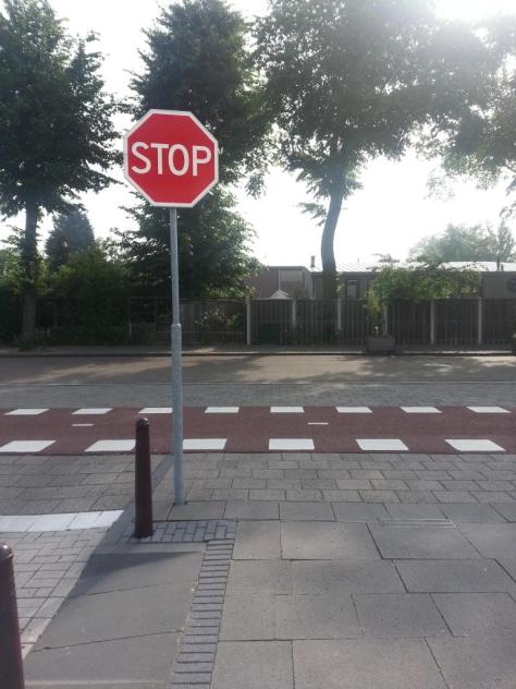 Also from Ine at the same location: The location of the stop sign is here: http://goo.gl/maps/64Mcj. You won’t be able to see it on Google Streetview because they were still building when the satellite picture was taken. But it’s right where you see the white squares on the bicycle path. The white squares are also a sign, painted on the street, to warn drivers to slow down because of the bicycle path. 